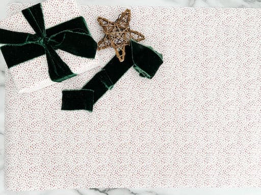 gold wrapping paper with a velvet green bow