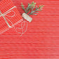 red and white striped gift wrapping paper with a bow