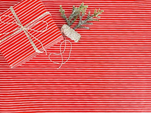 red and white striped gift wrapping paper with a bow