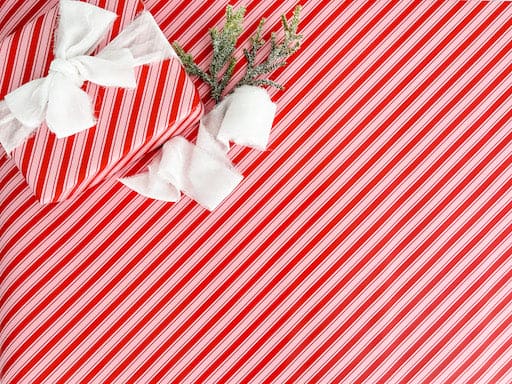 candy cane striped wrapping paper with a white bow