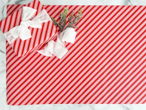 candy cane striped wrapping paper with a white bow