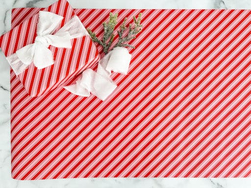 cand cane wrapping paper with a velvet white bow