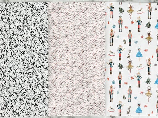 3 rolls of christmas wrapping paper, including nutcracker, floral and boho spots