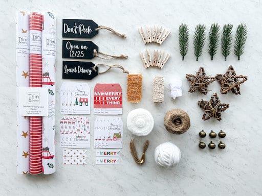 Complete Christmas Wrapping Paper set with extras like white velvet ribbons, stars, bells and yarn wool