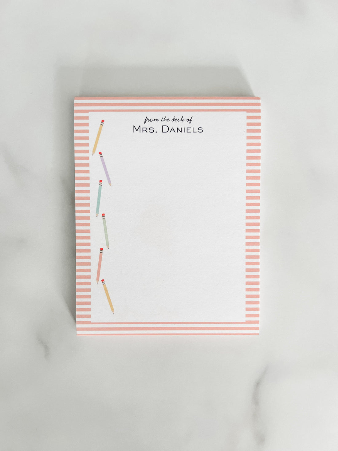 Personalized teacher notepad with colorful pencils and a striped edge.