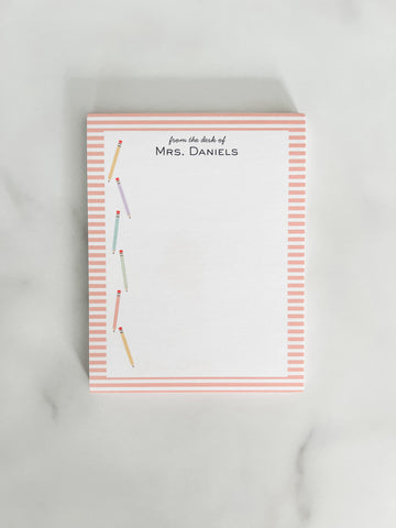 Personalized teacher notepad with colorful pencils and a striped edge.