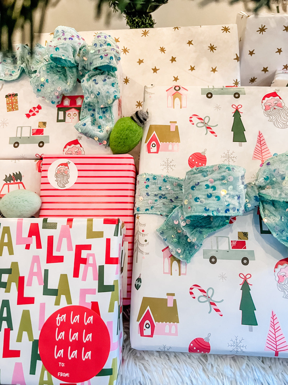 Gift wrap with festive designs and ribbons on a wooden surface